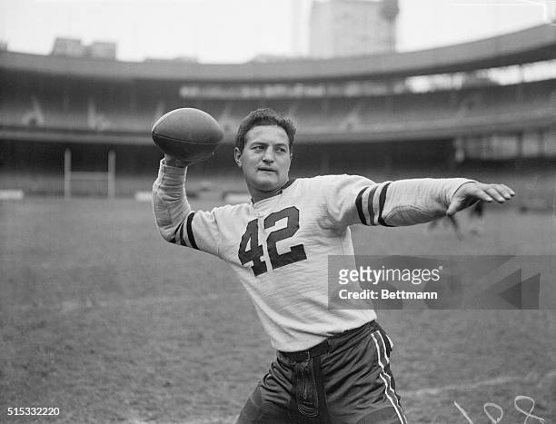 New York, New York: Sid Luckman, a local boy who made good with the grid warriors of Columbia University, shows off the passing technique that won...