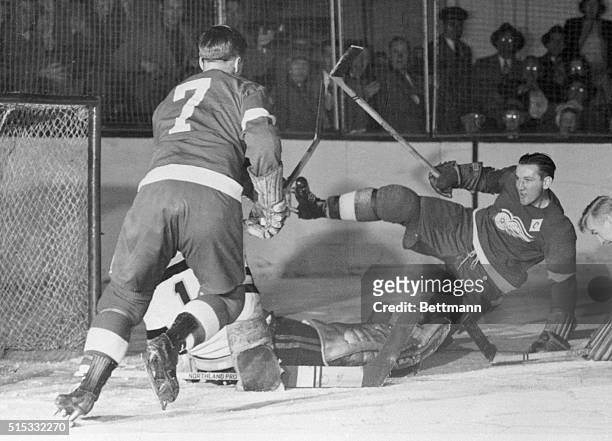 Sid Abel, , Detroit Red Wings captain, makes a mighty swing and throws himself of balance in the hockey game against the Boston Bruins. While...