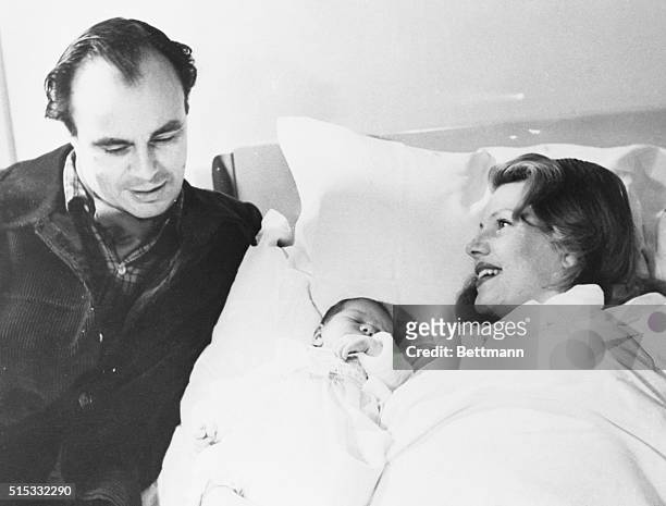 Prince Aly Khan and actress Rita Hayworth pose with their 4-day-old daughter who sleeps unconcerned as the first pictures of the family are snapped....