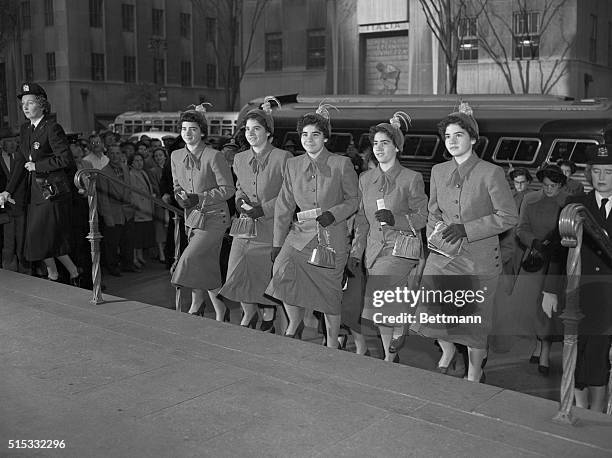 Wearing identical outfits, the famed Dionne Quintuplets of Canada arrive at St. Patrick's Cathedral, Oct. 20, to attend Roman Catholic services. The...