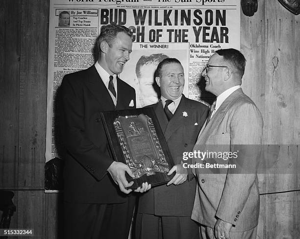 Coach Charles "Bud" Wilkinson of Oklahoma, chats here with Joe Williams, , the executive sports editor of Scripps-Howard Newspapers, and L. R....