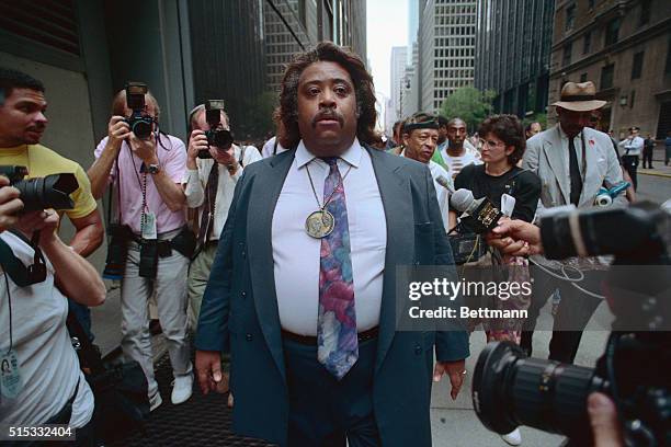 Democratic senatorial hopeful Rev. Al Sharpton walks away from the hotel where Gov. Bill Clinton is staying for the Democratic National Convention...