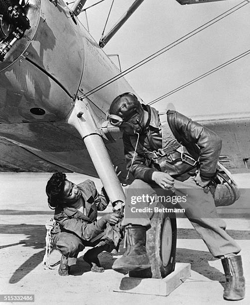 This might be a romance but actually the young Negro girl, Marjorie Dorsey, apprentice mechanic of Birmingham, Alabama, is doing a job on the plane...