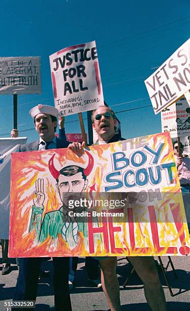 San Carlos, California: Alan Horn of Burlingame, CA. And Keith Mather of Montara, CA. Protest Oliver North's appearance in front of the Circle Star...