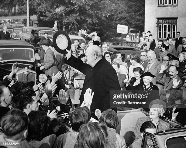 Churchill, Tory Leader, stand in the rear of a car to address this crowd ar Woodford, his constituency in the forthcoming general election. Mrs....