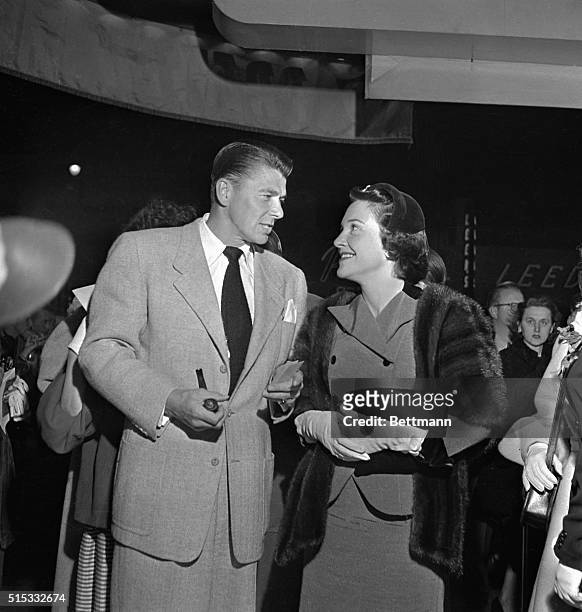 Hollywood, CA: Actor Ronald Reagan speaks with Nancy Davis at the Press Preview of "I Was a Communist for the F.B.I." at the Warner Bros. Theater in...