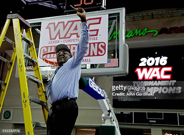 Head coach Rod Barnes of the Cal State Bakersfield Roadrunners celebrates cutting a piece of the net after beating the New Mexico State Aggies 57-54...