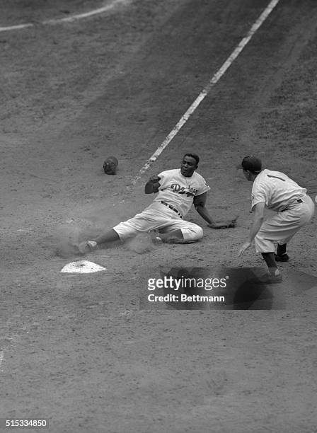 Brooklyn's Jackie Robinson slides in safely at home plate, scoring from first base in the sixth inning of the clash with the New York Giants. Catcher...