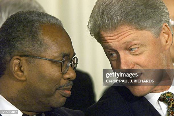 President Bill Clinton speaks with Ernest Green , the only senior high school student among the Little Rock Nine and the first African-American...