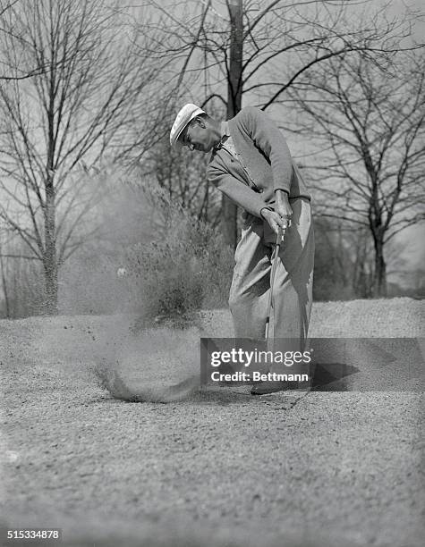 Golf pro Ben Hogan raises one out of the trap during a practice round on the Oakland Hills Country Club course. Hogan is getting ready for the U.S....