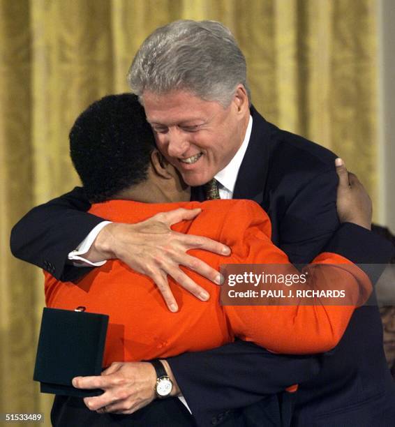 President Bill Clinton hugs Elizabeth Eckford during the presentation of the Congressional Gold Medal to the members of the Little Rock Nine 09...