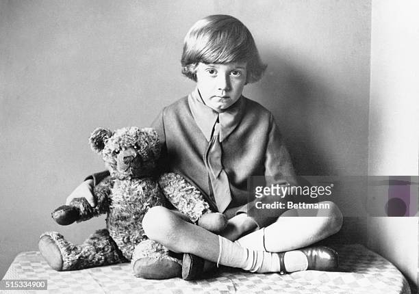 Winnie the Pooh author A.A. Milne's son, Christopher Robin, sitting at home with his teddy bear, circa 1925.