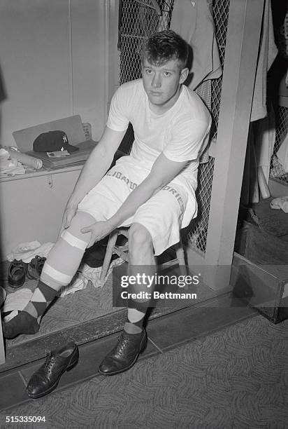 Mickey Mantle tests his taped shin in the Yankee dressing room, after spraining a knee while going after Willie Mays' long fly to centerfield in the...