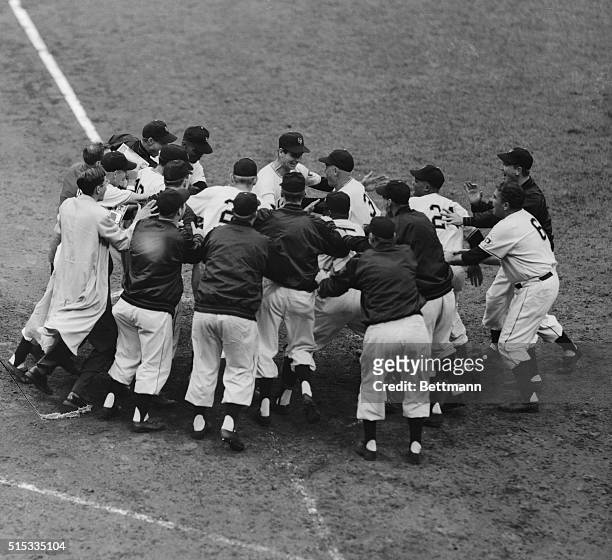 Jubilant Giants swarm around a grinning Bobby Thomson as he dents the plate to make his three-run homer official in the ninth inning of the final...