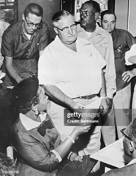 Mrs. Mamie Bradley of Chicago, is handed a subpoena by Sheriff H. C. Strider to testify in the trial of two white men charged with murdering her...