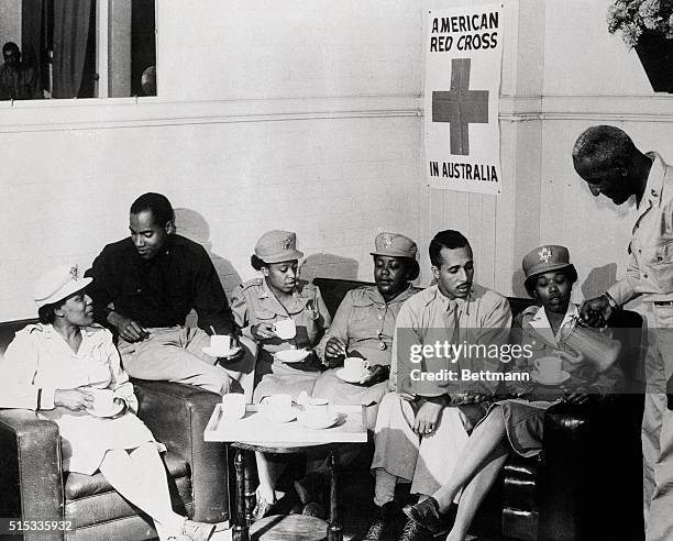 American Red Cross club director Harvey Shaw, of Philadelphia, PA, pours out coffee for US Army nurses and officers serving in the Southwest Pacific....