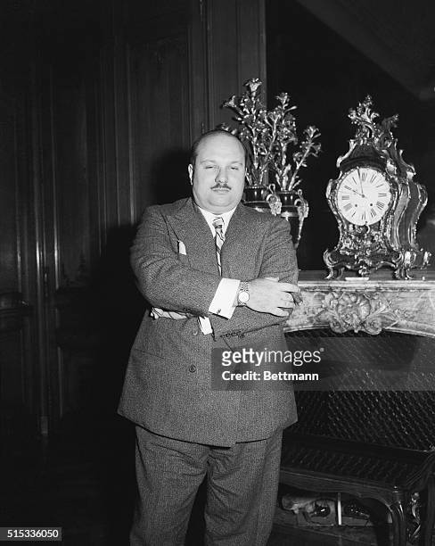 Looking calm and collected after a futile attempt to evade news photographers upon his arrival in Paris by train, ex-king Farouk sportingly poses for...