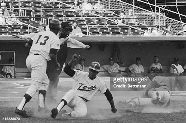 Twins' Rod Carew slides safely across home plate for his seventh steal of home in as many tries during the second inning of the Minnesota-Chicago...
