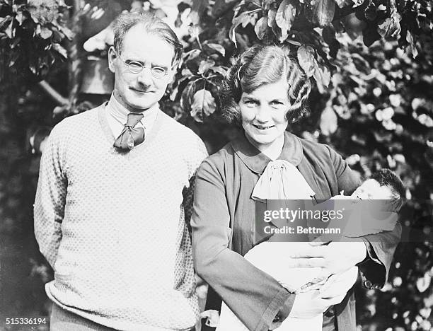 Irish playwright Sean O'Casey poses with his wife and baby son.