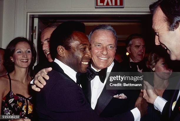 Putting their talents to use for the big city, soccer superstar Pele and Frank Sinatra greet each other at the $1,000-a-plate dinner held here 4/2 to...