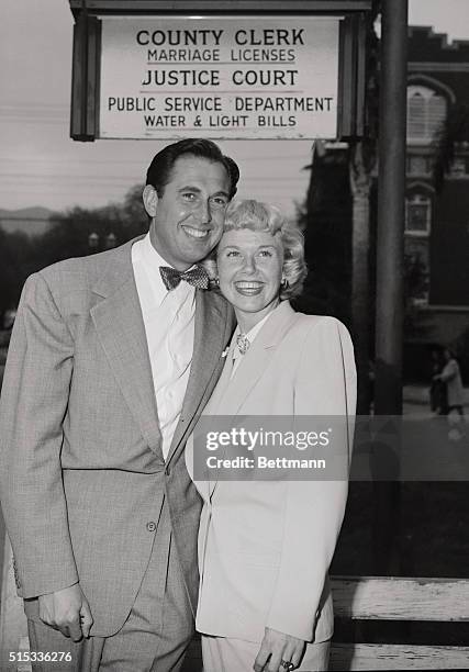 All smiles, screen actress singer Doris Day and hubby manager Marty Melcher pose for a momentous snapshot after a quiet marriage ceremony at Burbank...