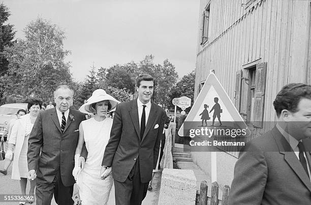 British actor David Cameron and German screen actress Hildegard Knef hold each other by the hand as they use a school-children cross over en route to...