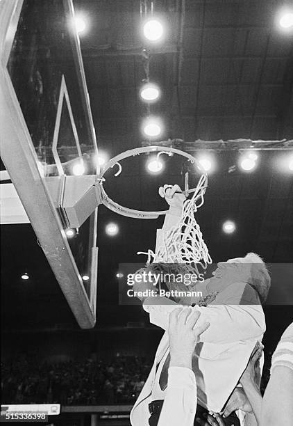 DePaul coach Ray Meyer cuts down the net after the Blue Demons won their final regular season game against Marquette 64-49 at the Horizon 3/10. The...
