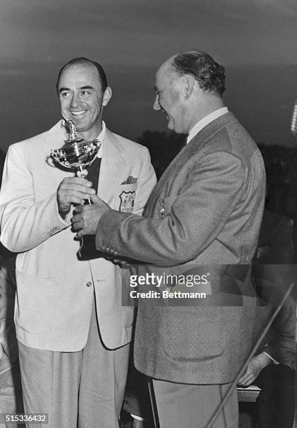 Captain Sam Snead, of the American team receives the coveted Ryder Cup for his team from Joe Novak , President of the Professional Golfers...