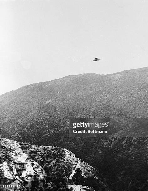 Riverside, California: Guy B. Marquand, Jr., who made this picture on a mountain road near here, says the object above the skyline is a "flying...