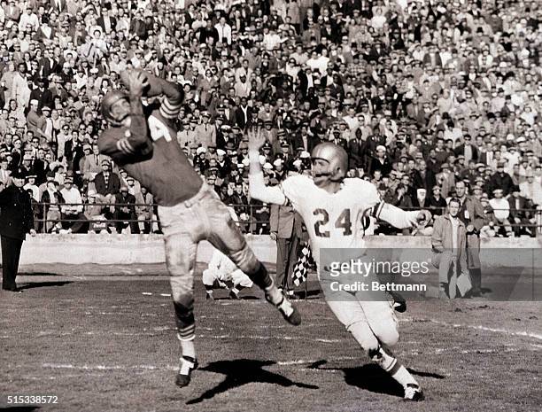 Forty-Niner end Billy Wilson snags pass from teammate Y.A. Tittle, good for a touchdown in the second quarter of clash with Detroit Lions at Kezar...