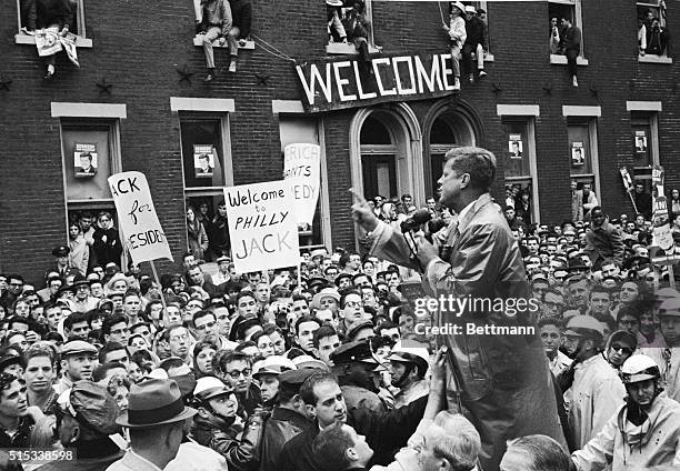 Senator John F. Kennedy talks to Temple University students here October 31st, including an overflow crowd in the windows of one of the campus...