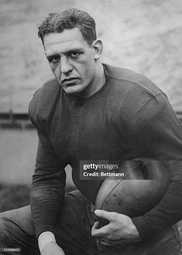 Red Grange Holding Football