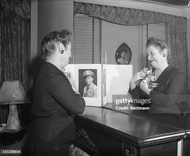 This is a very happy Mother's Day for Mrs. Norma Seifter for she received the orchid she is shown pinning to her dress from her son, Lieutenant...