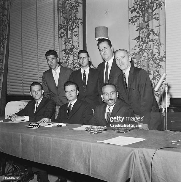 Members of Cuban Invasion Brigade 2506 get together during news conference at the Overseas Press Club here January 18. Seated, left to right, are...
