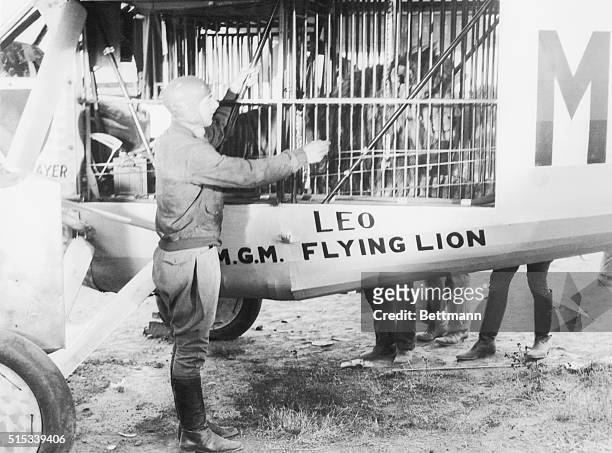 Aviator Marten Jensen, second place winner in the 1927 Dole Trans-Pacific Air Race, pictured with the MGM studios lion, Leo. Marten planned to fly...