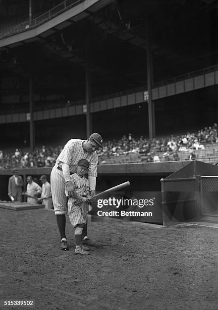 Photo shows Little Johnny Dell, nine years old, proud right fielder of the Hudson Park Baseball Team, talking about real baseball with Babe Ruth. The...