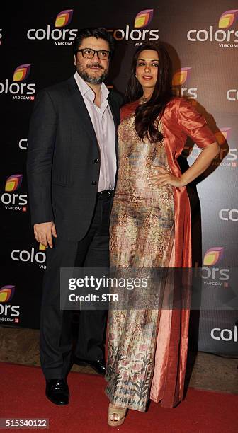 Indian Bollywood actress Sonali Bendreposes with her husband Goldie Behl as they attend The Colors Television Annual Party in Mumbai late March 12,...