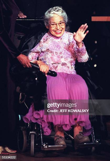 Civil rights icon Rosa Parks waves to the audience before receiving the Congessional Medal of Honor at a ceremony 28 November 1999 in Detroit. Mrs....