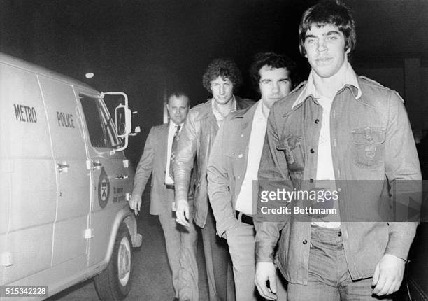 Mel Bridgman , Joe Watson and Don Saleski of the Philadelphia Flyers turn themselves into police here today after warrants were issued for their...