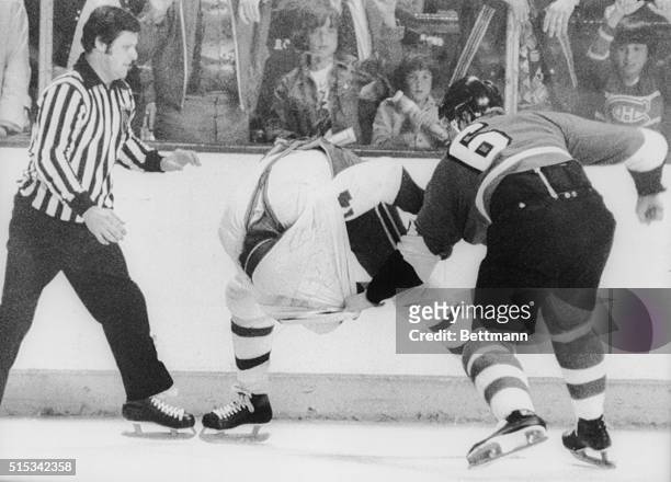 Philadelphia defenseman Andre Dupont and Montreal's Mario Tremblay battle it out during 2nd period action. Linesman Neil Armstrong watches the fight...