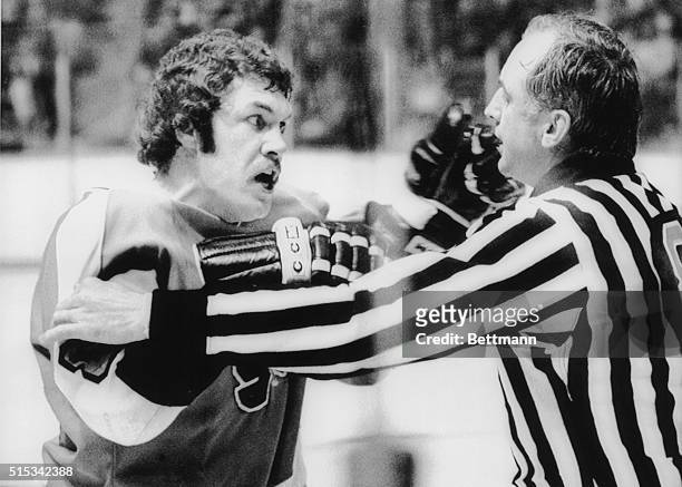 Dave Schultz of the Philadelphia Flyers shows his displeasure with linesman Neil Armstrong after being given a misconduct penalty during a game...