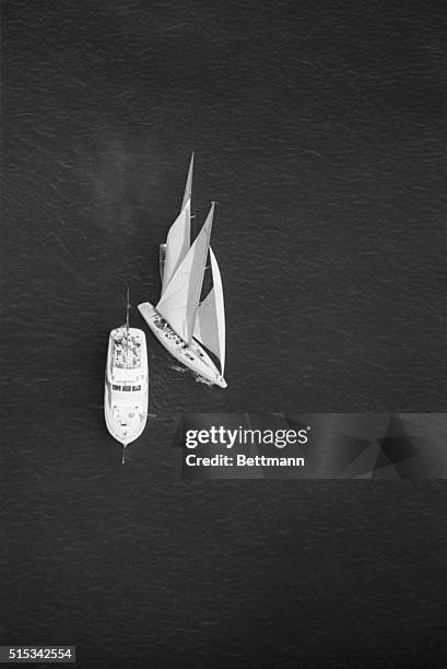 Intrepid, left, and Gretel II approach the America's Cup committee boat in the left picture, and then collide seconds before the start of the second...