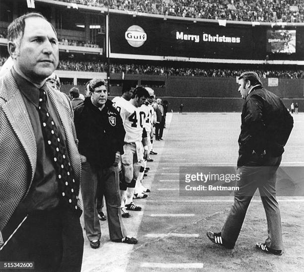 'Merry Christmas' flashes above Oakland Raider coach John Madden as he stalks from the field after losing to the Pittsburgh Steelers 13 to 7. A pass...