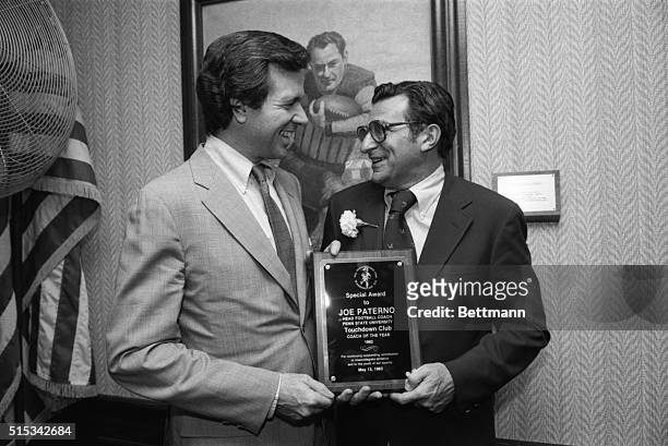 Sen. John Heinz, R-Pa., , presents Penn State University's football coach Joe Paterno with a plaque in honor of being named Coach of the Year by the...