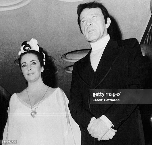 Richard Burton and his wife, Elizabeth Taylor, who?s wearing the heart-shaped diamond pendant which drove away her tears, arrive at a $72,000...
