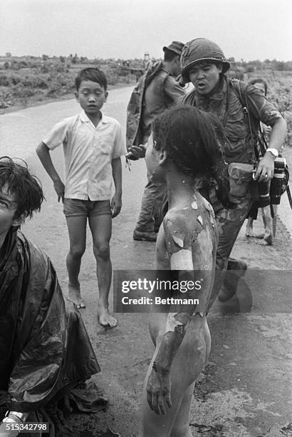 Vietnamese children flee from their homes in the South Vietnamese village of Trang Bang after South Vietnamese planes accidently dropped a napalm...