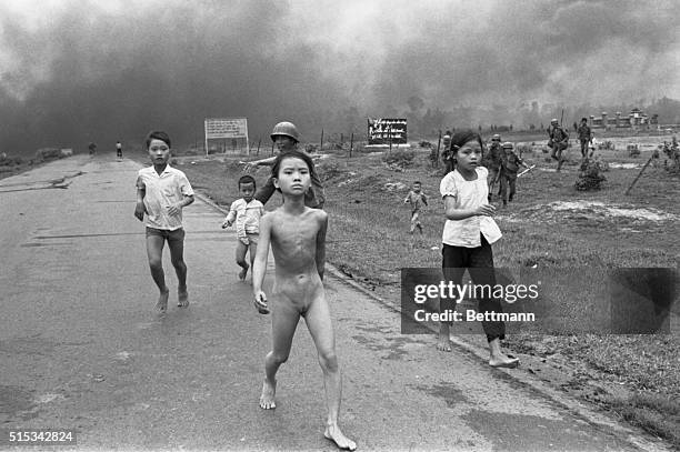 Vietnamese children flee from their homes in the South Vietnamese village of Trang Bang after South Vietnamese planes accidently dropped a napalm...