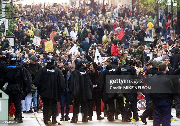 Riot police and tens of thousands of demonstrators face-off near the Paramount Theater where the World Trade Organization Summit in Seattle,...