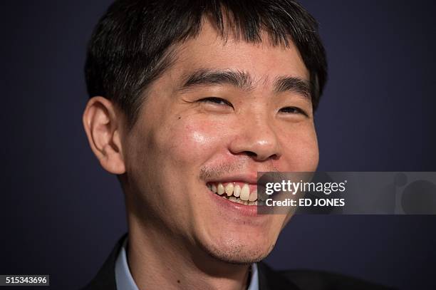 'Go' player Lee Se-Dol smiles during a post-match press conference after his first win against a Google-developed super-computer, in Seoul on March...