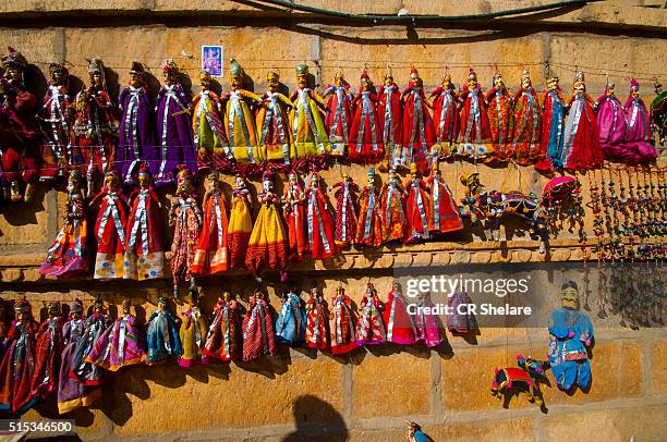 colorful puppets against wall - india market color sari stock pictures, royalty-free photos & images